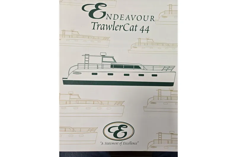 Slide: The Image of Endeavour Trawler Cat 44 brochure cover, featuring boat illustrations and logo, 2003 model. - 110