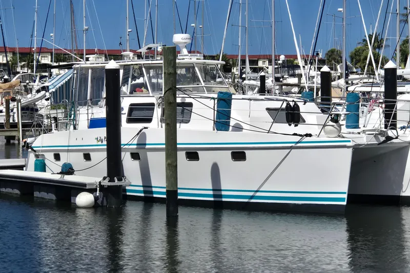 Slide: The Image of 2003 Endeavour Trawler Cat 44 docked in a marina with sailboats. - 115