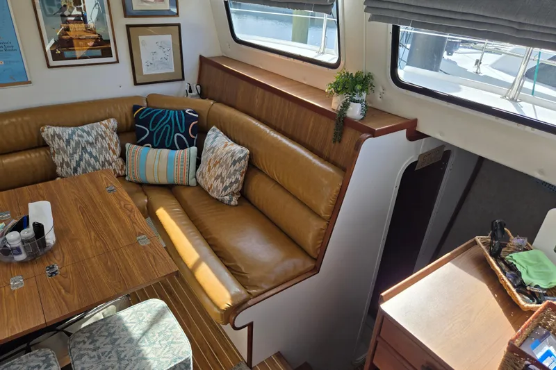 Slide: The Image of Interior of 2003 Endeavour Trawler Cat 44 with cozy seating and decorative pillows. - 14
