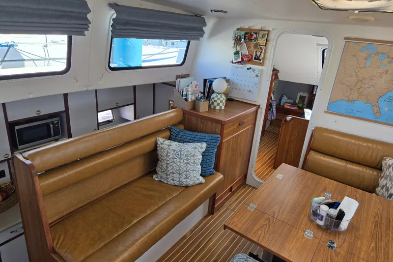 Slide: The Image of Interior of 2003 Endeavour Trawler Cat 44 with cozy seating and nautical decor. - 15
