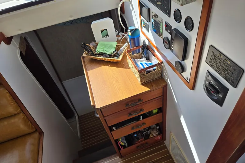 Slide: The Image of Interior of 2003 Endeavour Trawler Cat 44 with control panel and wooden cabinetry. - 16