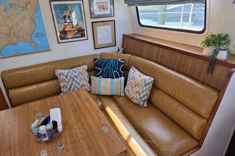 Slide: The Image of Cozy interior of 2003 Endeavour Trawler Cat 44 with leather seating, pillows, and wall art. - 19