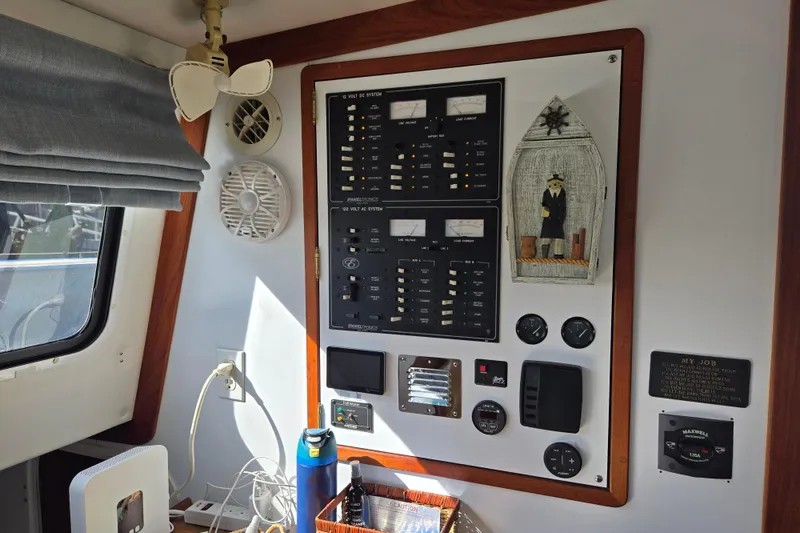 Slide: The Image of Control panel inside 2003 Endeavour Trawler Cat 44, featuring gauges, switches, and nautical decor. - 21