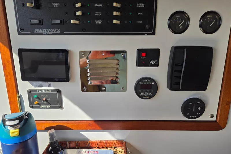Slide: The Image of Control panel of a 2003 Endeavour Trawler Cat 44 with various switches and gauges. - 23