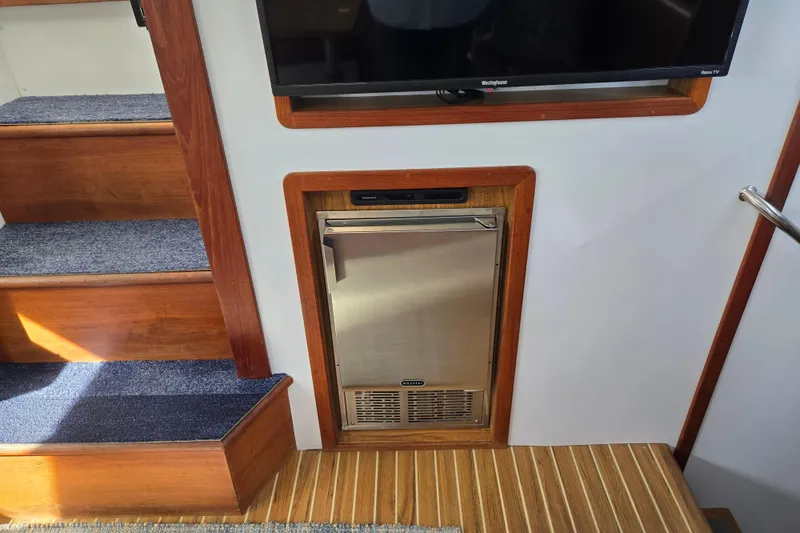 Slide: The Image of Interior of 2003 Endeavour Trawler Cat 44 with wooden stairs and built-in refrigerator. - 26
