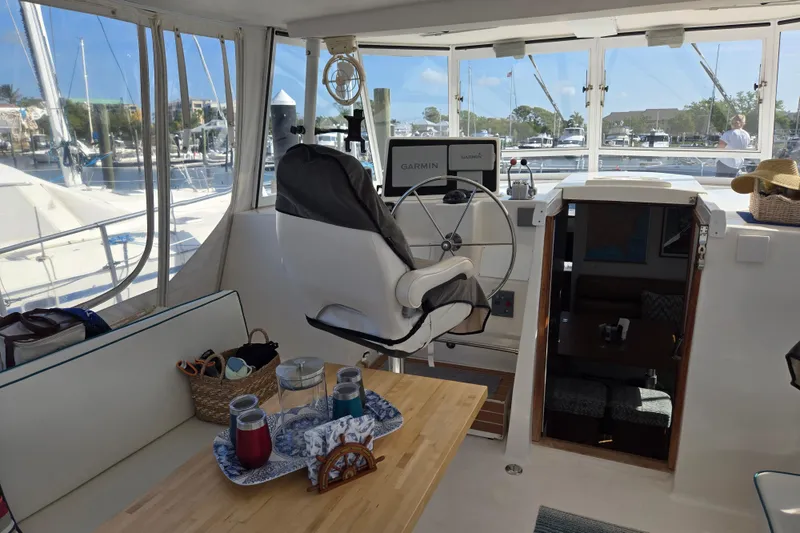 Slide: The Image of Interior of 2003 Endeavour Trawler Cat 44 with helm, seating, and navigation equipment. - 3