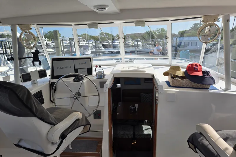 Slide: The Image of Helm of 2003 Endeavour Trawler Cat 44 with Garmin navigation, docked at marina. - 33