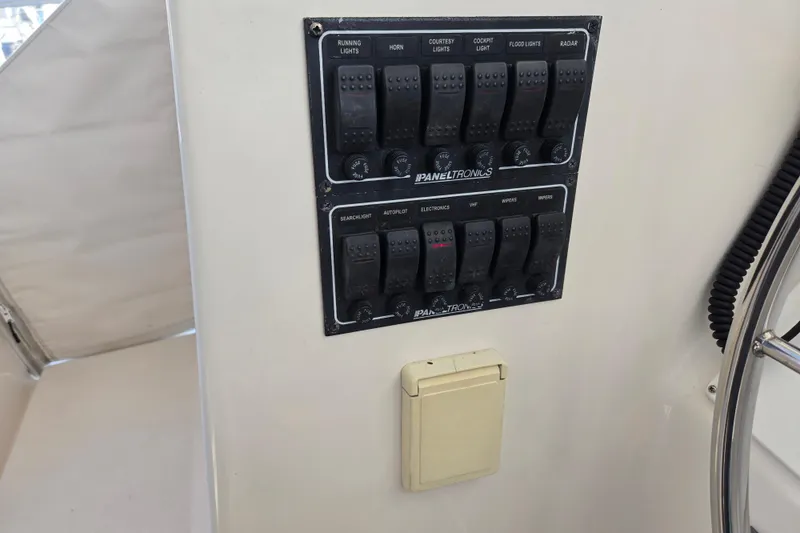 Slide: The Image of Control panel on 2003 Endeavour Trawler Cat 44, featuring various switches and dials. - 42