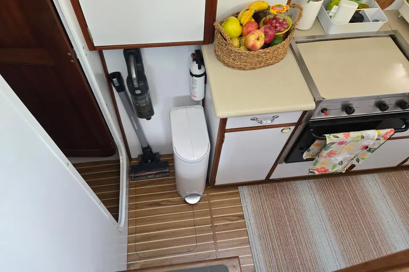 Slide: The Image of Compact kitchen area in a 2003 Endeavour Trawler Cat 44 with fruit basket and appliances. - 47