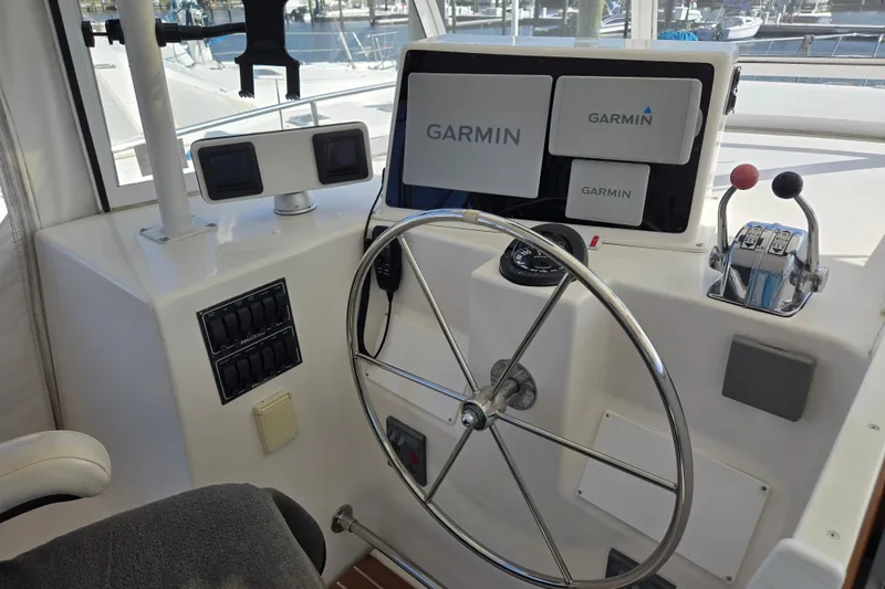 Slide: The Image of Helm of 2003 Endeavour Trawler Cat 44 with Garmin navigation system and steering wheel. - 5