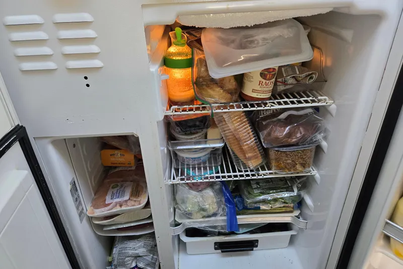 Slide: The Image of Freezer stocked with various food items on an Endeavour Trawler Cat 44, 2003 model. - 52