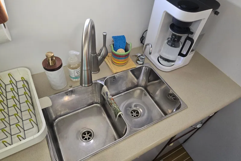 Slide: The Image of Kitchen sink area on 2003 Endeavour Trawler Cat 44 with coffee maker and dish rack. - 53