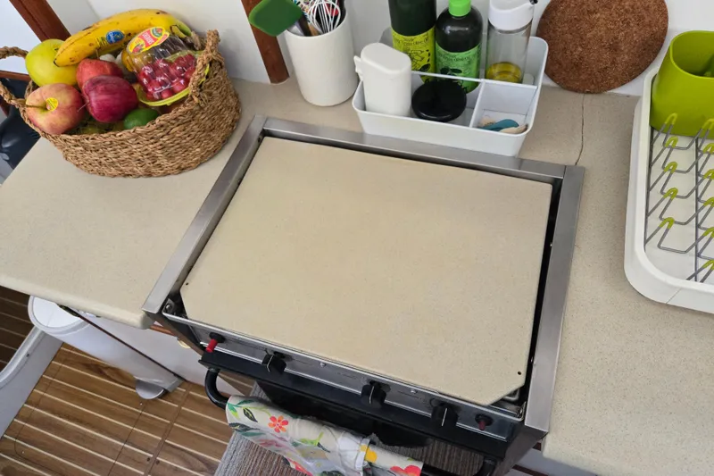 Slide: The Image of Kitchen area of 2003 Endeavour Trawler Cat 44 with stove and fruit basket. - 55