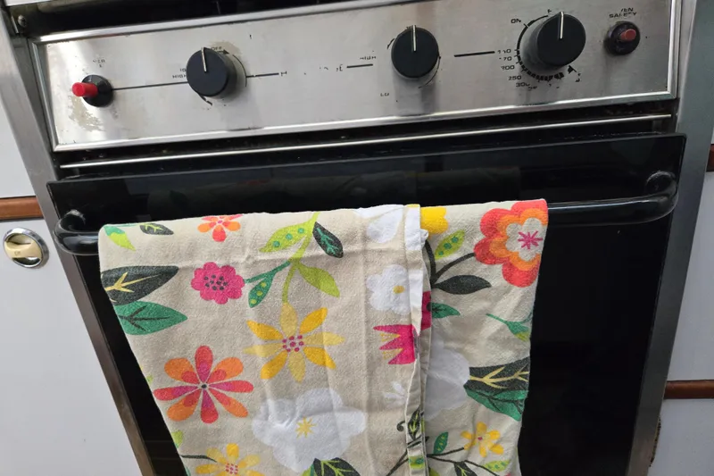 Slide: The Image of Stainless steel oven with floral towel, Endeavour Trawler Cat 44, 2003 model. - 56