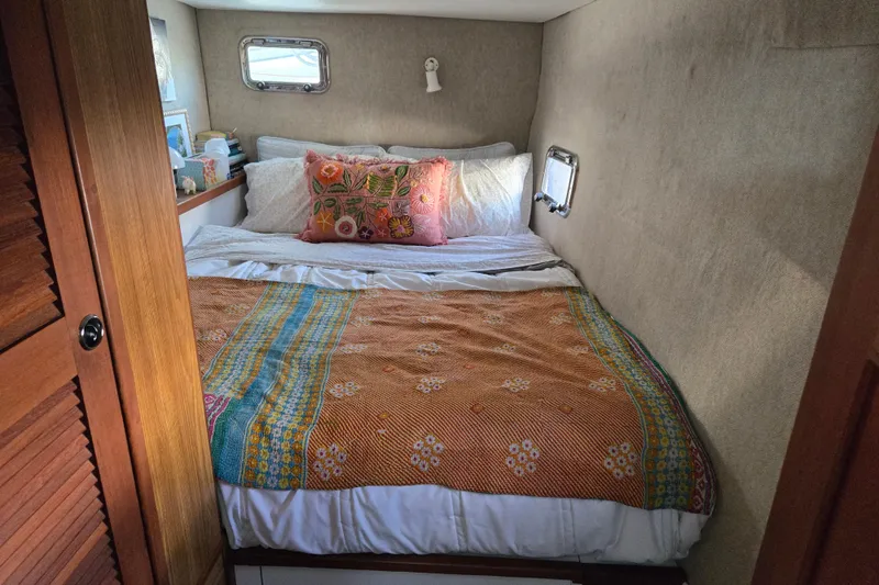Slide: The Image of Cozy bedroom in 2003 Endeavour Trawler Cat 44 with colorful bedding and porthole windows. - 58