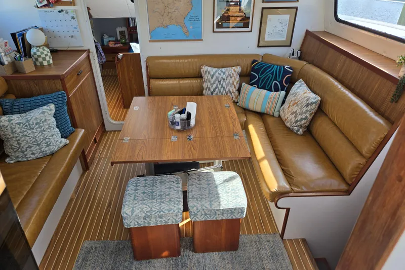 Slide: The Image of Interior of 2003 Endeavour Trawler Cat 44 with cozy seating and decorative pillows. - 6