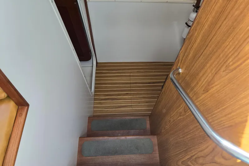 Slide: The Image of Staircase inside 2003 Endeavour Trawler Cat 44 with wooden steps and handrail. - 61
