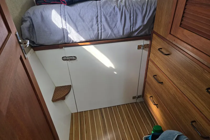 Slide: The Image of Cozy cabin interior of 2003 Endeavour Trawler Cat 44 with wooden drawers and bed. - 63