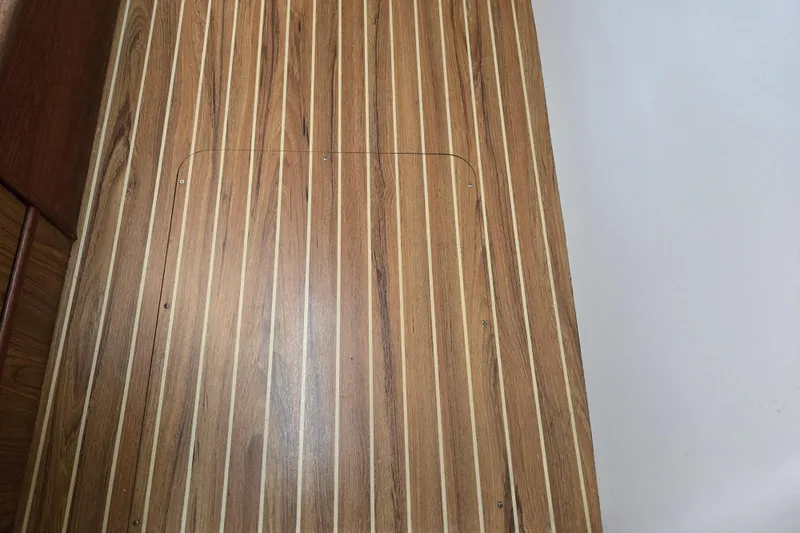 Slide: The Image of Wooden deck of 2003 Endeavour Trawler Cat 44 with sleek, parallel lines. - 66