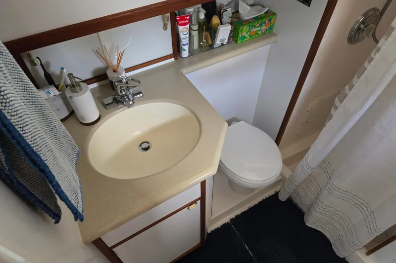 Slide: The Image of Bathroom interior of 2003 Endeavour Trawler Cat 44 with sink, toilet, and toiletries. - 67