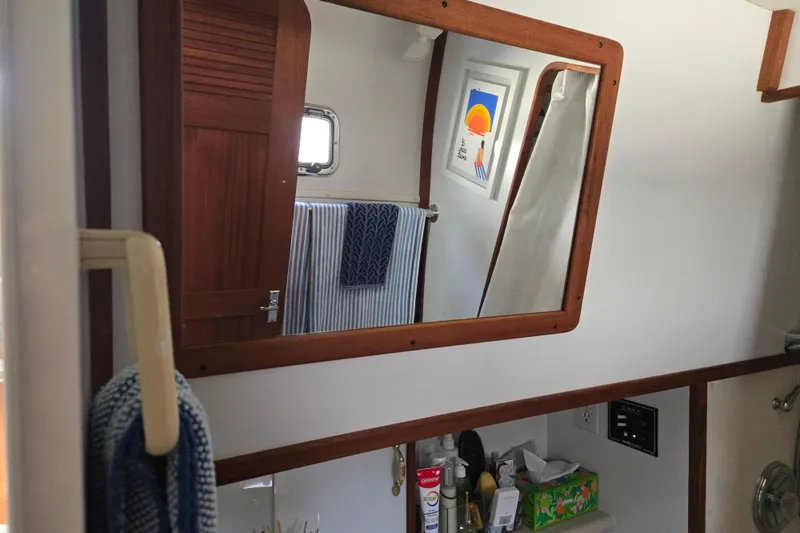 Slide: The Image of Interior of 2003 Endeavour Trawler Cat 44 bathroom with mirror, towels, and toiletries. - 68