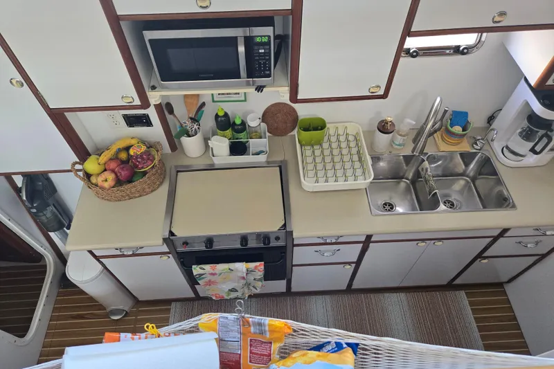 Slide: The Image of Kitchen area of 2003 Endeavour Trawler Cat 44 with appliances and fruit basket. - 7