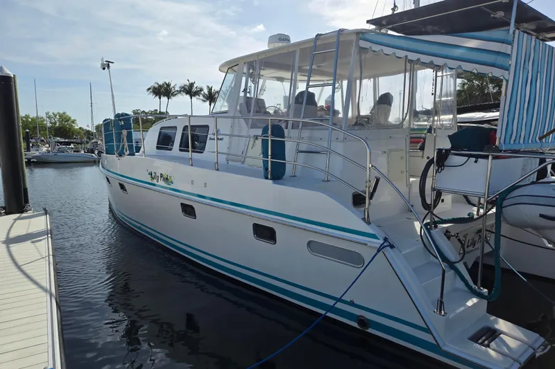 Slide: The Image of 2003 Endeavour Trawler Cat 44 docked at marina, featuring sleek design and spacious deck. - 74