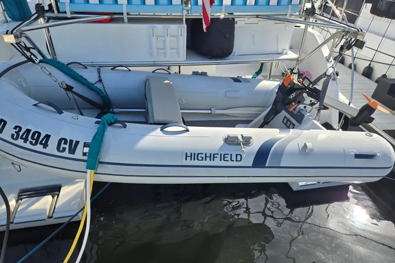 Slide: The Image of Inflatable dinghy attached to 2003 Endeavour Trawler Cat 44, docked at marina. - 77