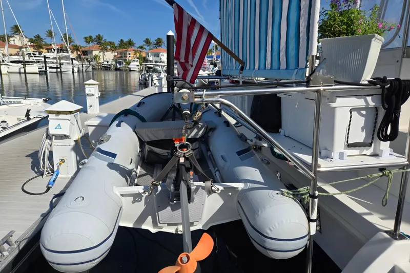 Slide: The Image of 2003 Endeavour Trawler Cat 44 with inflatable dinghy docked at marina. - 78