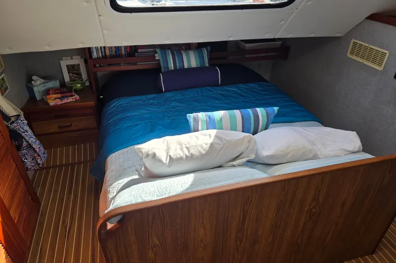 Slide: The Image of Cozy bedroom in 2003 Endeavour Trawler Cat 44 with striped bedding and wooden accents. - 8