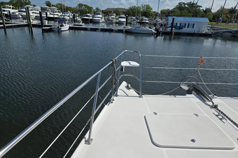 Slide: The Image of Bow view of 2003 Endeavour Trawler Cat 44 docked at a marina. - 83