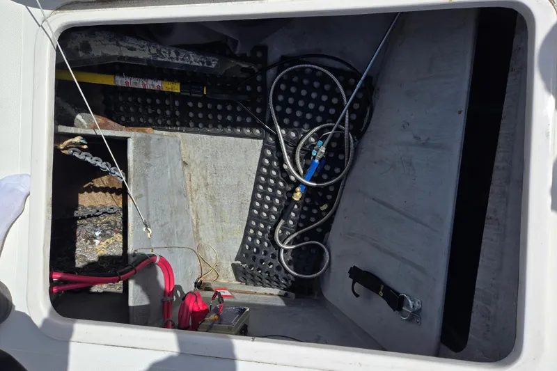 Slide: The Image of Storage compartment of a 2003 Endeavour Trawler Cat 44 with cables and equipment. - 87