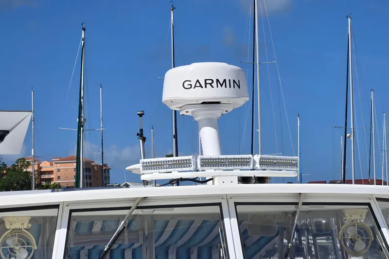Slide: The Image of Garmin radar on 2003 Endeavour Trawler Cat 44, with marina backdrop and clear blue sky. - 91