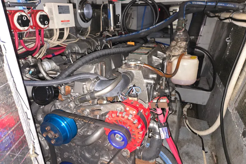 Slide: The Image of Engine room of a 2003 Endeavour Trawler Cat 44, showcasing mechanical components and wiring. - 94