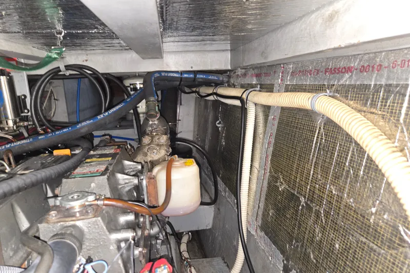 Slide: The Image of Engine room of 2003 Endeavour Trawler Cat 44 with visible hoses and components. - 95