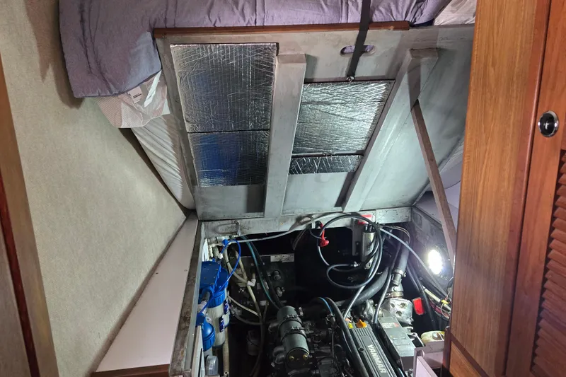 Slide: The Image of Engine room of a 2003 Endeavour Trawler Cat 44, showcasing mechanical components and insulation. - 97