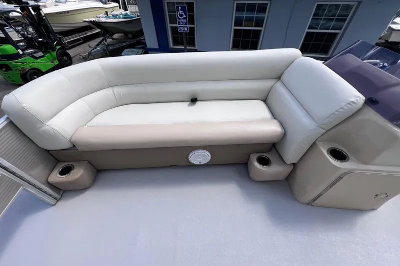 Slide: The Image of 2020 Godfrey Sweetwater 2286 Tritoon interior with beige seating and cup holders. - 11