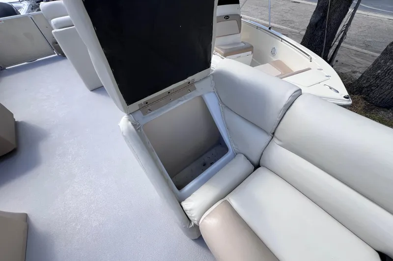 Slide: The Image of 2020 Godfrey Sweetwater 2286 Tritoon with open storage compartment on cushioned seating. - 13