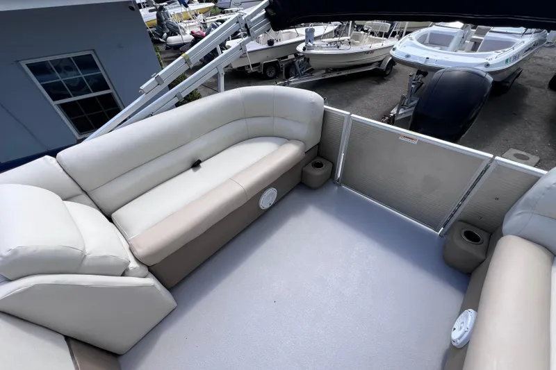 Slide: The Image of Interior view of 2020 Godfrey Sweetwater 2286 Tritoon with beige seating and cup holders. - 15