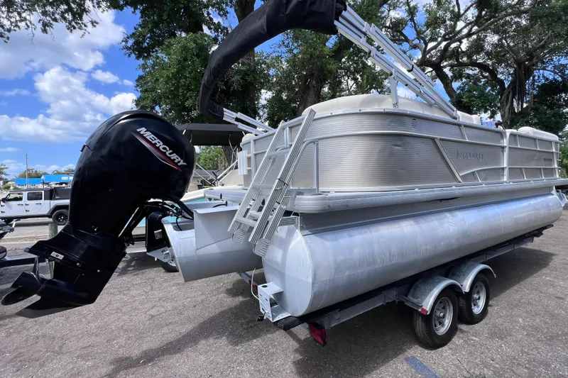 Slide: The Image of 2020 Godfrey Sweetwater 2286 Tritoon with Mercury outboard motor on trailer. - 2