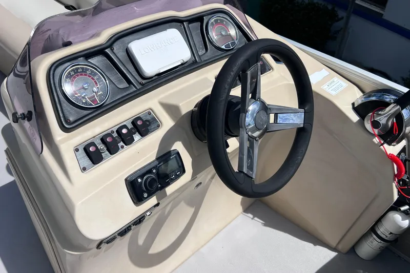 Slide: The Image of Steering console of a 2020 Godfrey Sweetwater 2286 Tritoon boat with gauges and controls. - 20