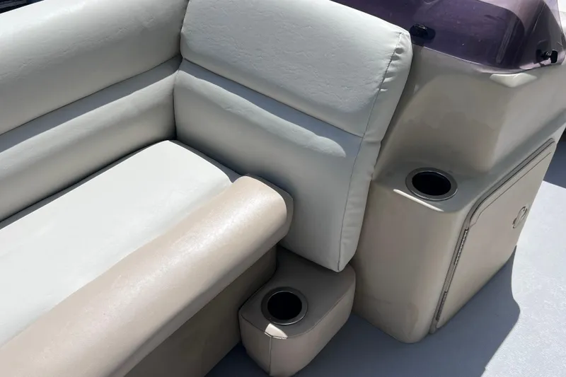 Slide: The Image of 2020 Godfrey Sweetwater 2286 Tritoon interior with beige seating and cup holders. - 24