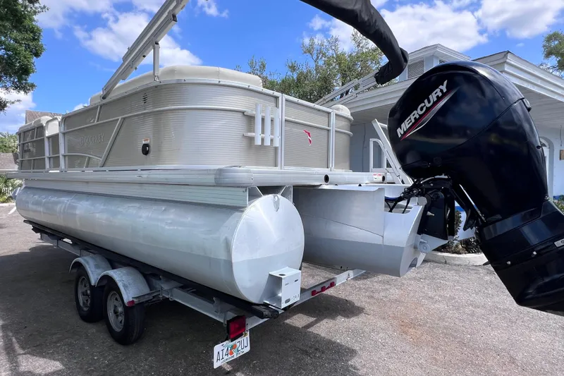 Slide: The Image of 2020 Godfrey Sweetwater 2286 Tritoon with Mercury engine on trailer, parked outdoors. - 4