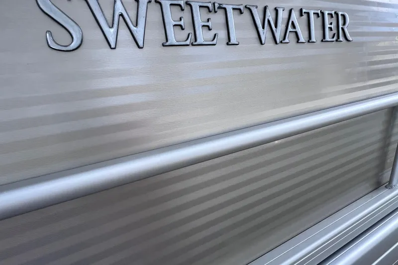Slide: The Image of Close-up of 2020 Godfrey Sweetwater 2286 Tritoon boat exterior with logo. - 7