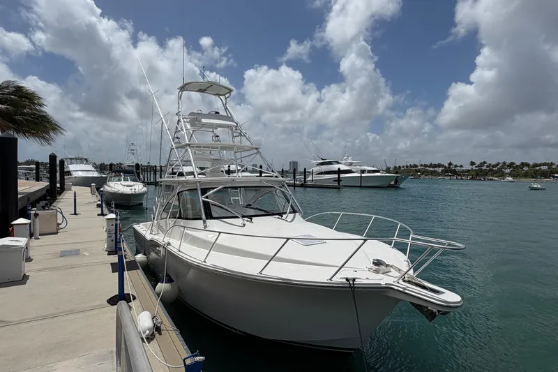 The Image of 2026 Albemarle 36 Express yacht docked at a marina under a partly cloudy sky. - 1