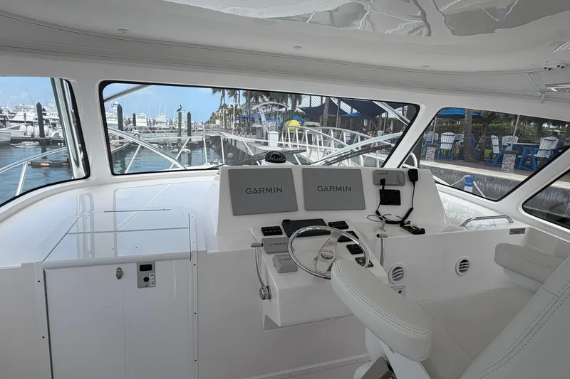 Slide: The Image of 2026 Albemarle 36 Express helm with Garmin navigation, docked at marina. - 10