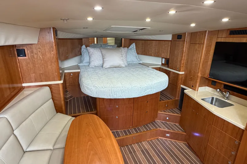 Slide: The Image of Luxurious interior of 2026 Albemarle 36 Express yacht with bed, seating, and kitchenette. - 7