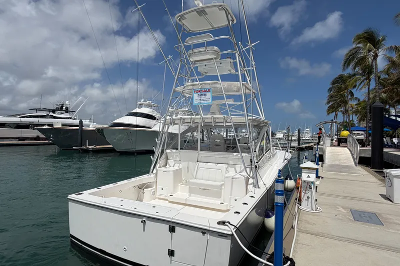 Slide: The Image of 2026 Albemarle 36 Express boat docked, for sale, with clear skies and palm trees. - 8