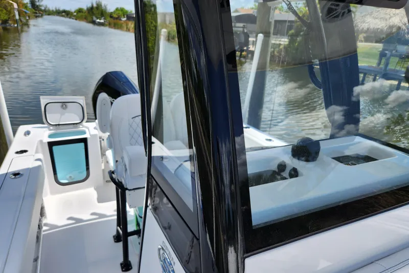 Slide: The Image of 2024 Sportsman Open 232 Center Console boat on a calm waterway. - 10