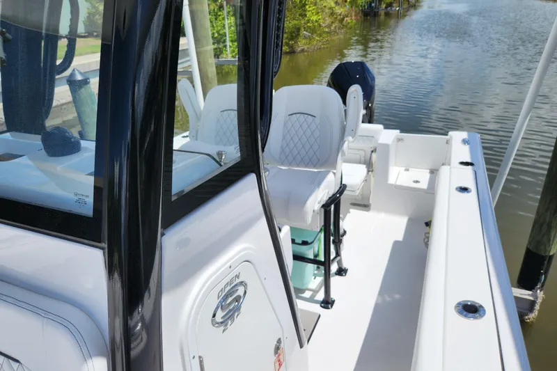 Slide: The Image of 2024 Sportsman Open 232 Center Console boat interior by the water. - 12